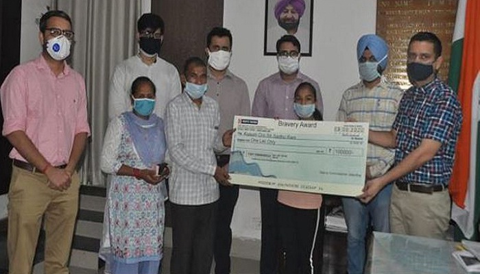 DC hands over Rs 1 lakh 