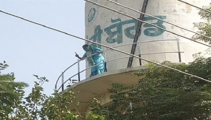 woman climbs water tank