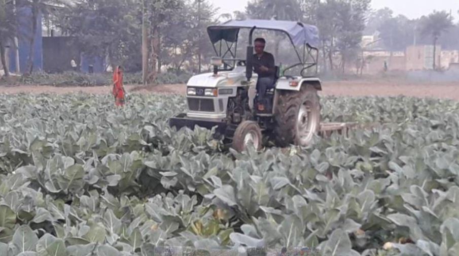 Farmer runs tractor
