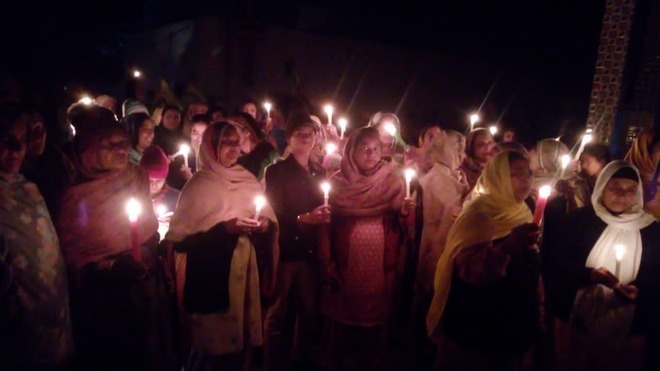 protesting farmers hold candle march